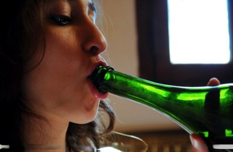 Horny teen Carol O sticks a wine bottle up her bald snatch on her bed 84366444