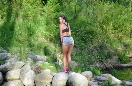 Gorgeous model Cindy Cupcakes undressing to bare her hot booty in the wild 92782501