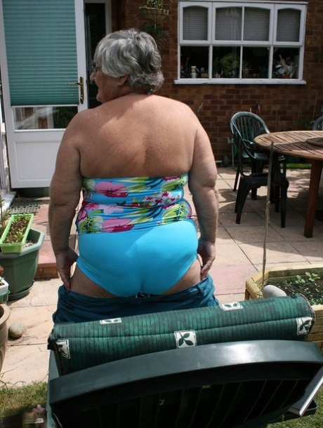 Naughty amateur granny Libby inserting a bottle in her fat pussy in the garden 17118577
