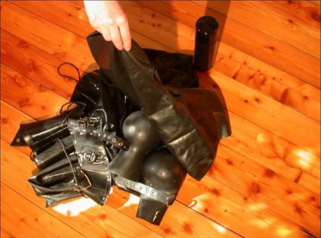 Naked blonde stands afore her discarded rubber clothing 50722114