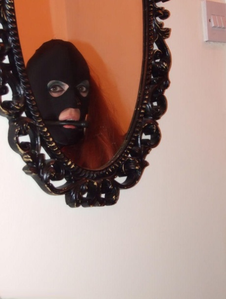 Fully clothed redhead sports a mask while gagged and bound as well 12368066