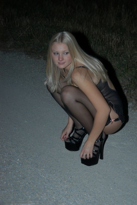 Young blonde Tiffany struts in black lingerie and stockings on a road at night 74191560