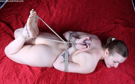 Naked white girl sports a ponytail while hogtied on top of a bed 70693333
