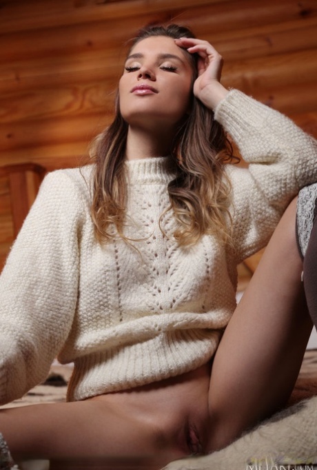 Gorgeous teen Emilia Hops doffs a big sweater to model nude in OTK hosiery 86993474