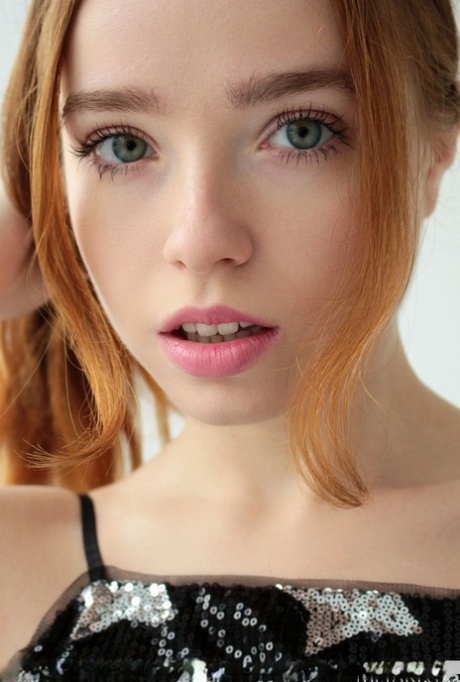 Sweet redheaded teen Rinna Ly unveils her great tits while getting naked 58176972
