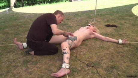 Submissive blonde is worked over by a sadist in a yard before giving a BJ 79207457