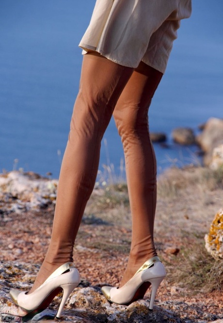MILF with curly blonde hair Eva Diangelo frees her panties on a seaside cliff 97154808