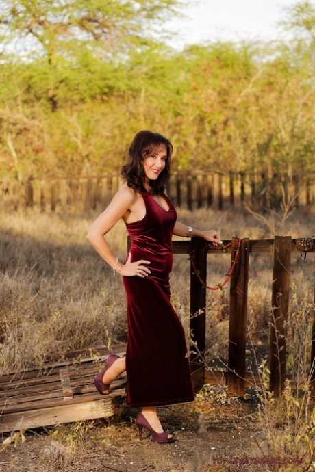 Mature woman Roni Ford steps out of velour dress for nude outdoor poses 99817374
